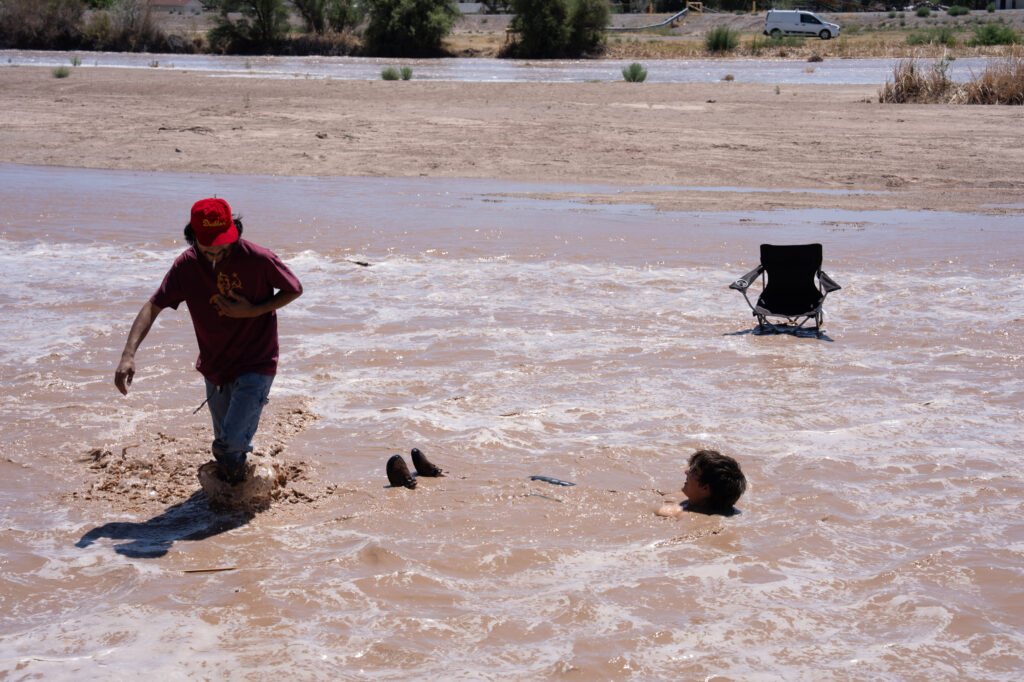 People enjoy the arrival of water at the Rio Grande in Las Cruces, N.M., on May 30.