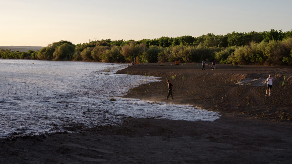 People watch as water flows down the Rio Grande in Mesilla on May 30.