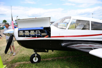 A 1964 Piper Comanche 400 is seen at the Experimental Aircraft Association’s AirVenture in Oshkosh, Wisc. The average single engine piston aircraft age is 50 years old. Credit: Andrew Liu/Inside Climate News