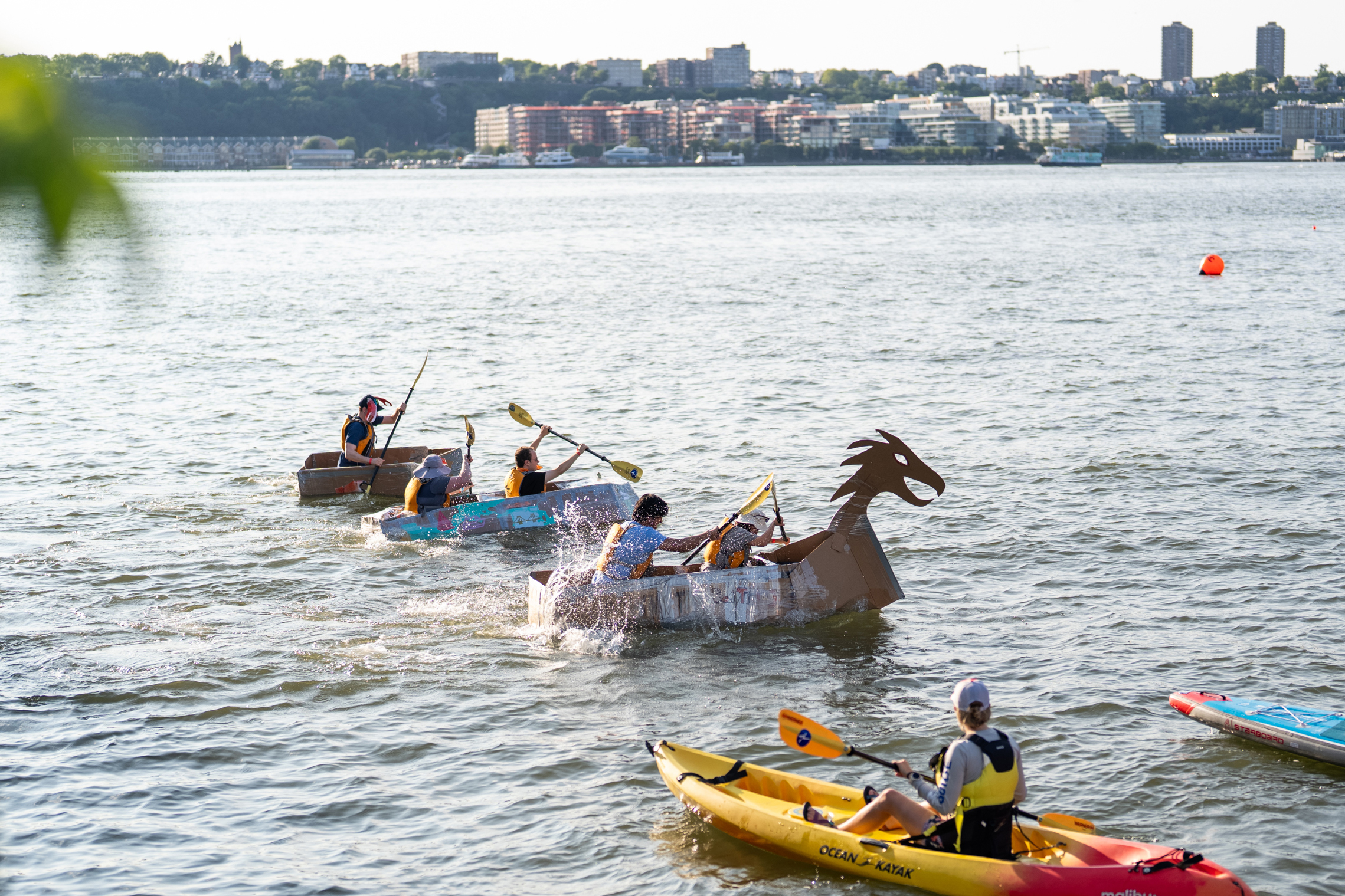 Contestants race cardboard kayaks on the Hudson River from Pier 84 in Manhattan on July 23. Credit: Jake Bolster/Inside Climate News