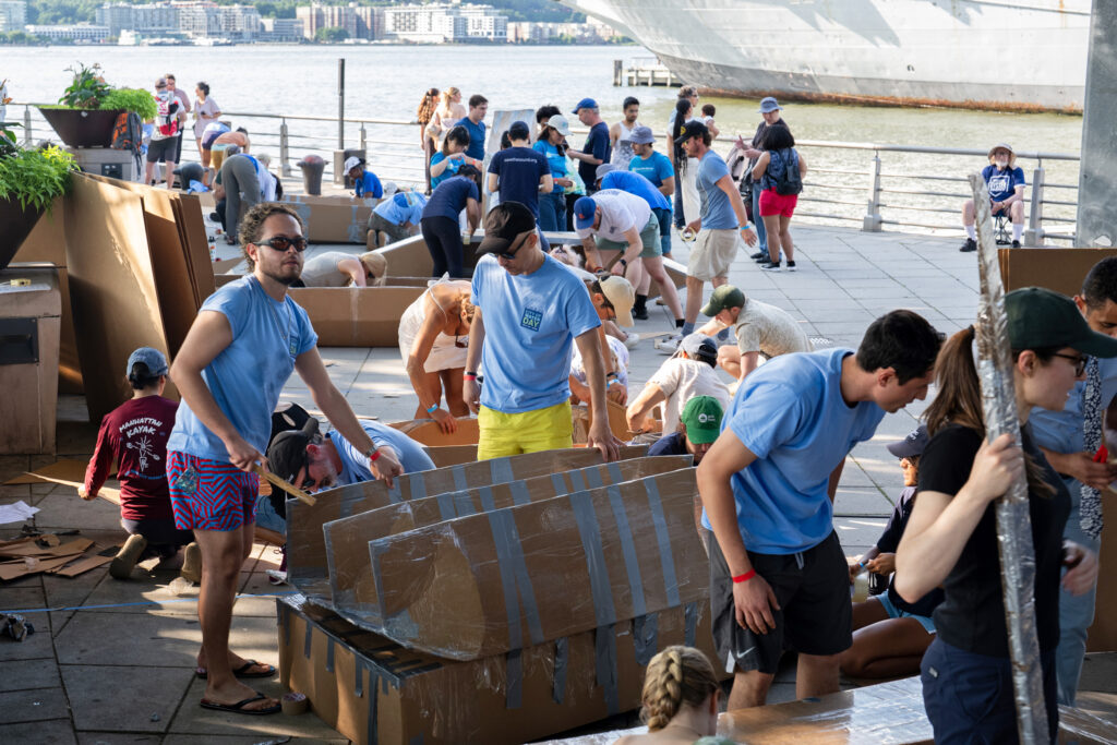 New Yorkers had a few hours to build their watercraft during the Cardboard Kayak Race on July 23. Credit: Jake Bolster/Inside Climate News