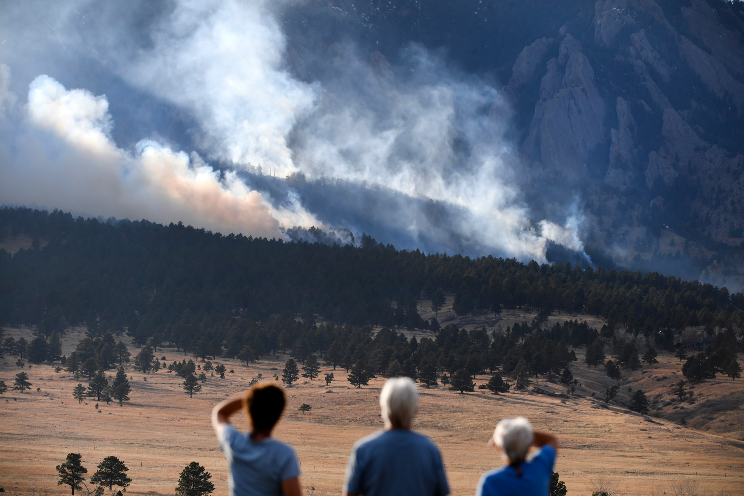 People watch as a wildfire burns in the foothills of Boulder, Colo., on March 26, 2022. Credit: Helen H. Richardson/The Denver Post via Getty Images
