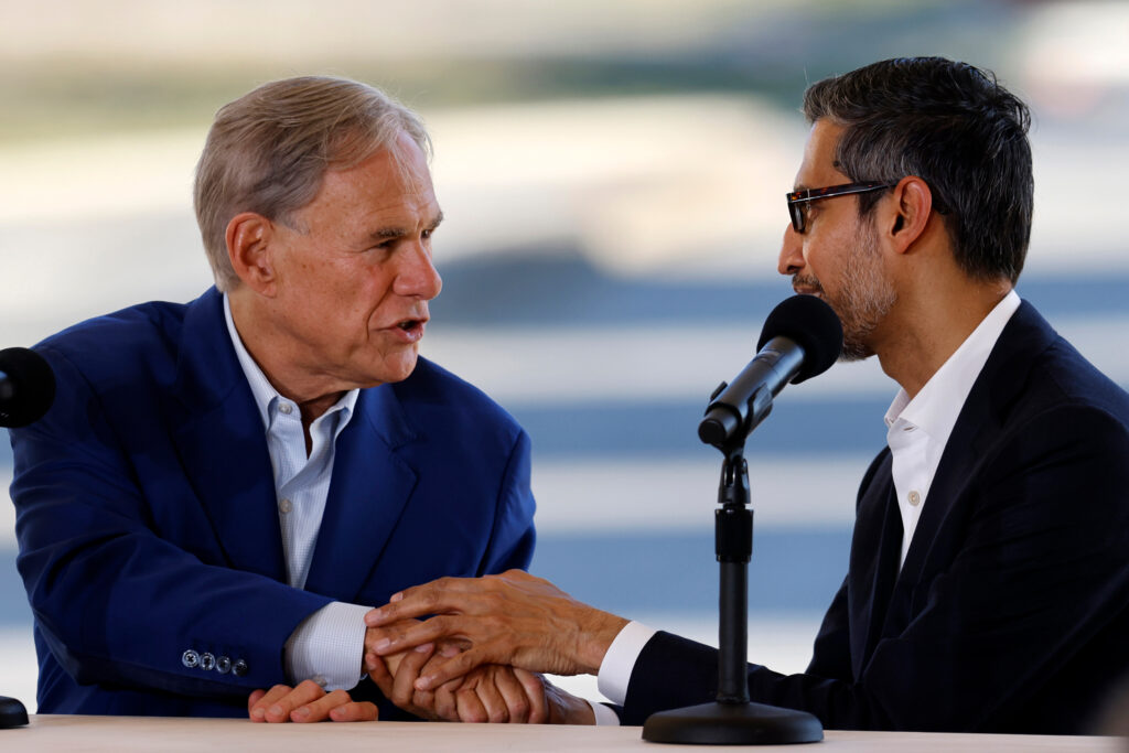 Gov. Greg Abbott (left) shakes hands with Alphabet and Google CEO Sundar Pichai at the Google data center in Midlothian, Texas, on Nov. 14, 2025. Credit: Ron Jenkins/Getty Images