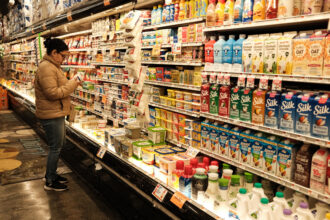 A woman shops for dairy products at a grocery story in New York City on April 9. Credit: Charly Triballeau/AFP via Getty Images