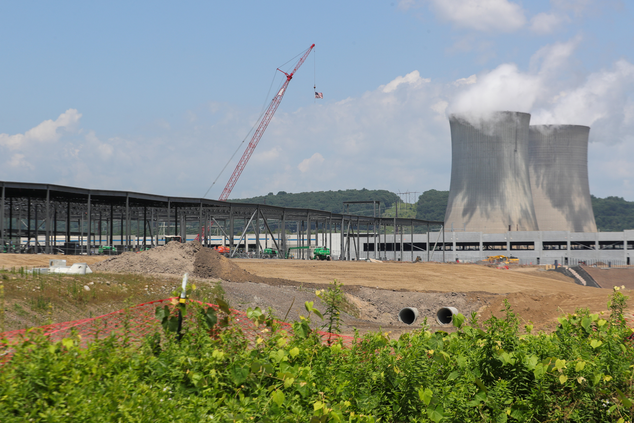 The cooling towers of Talen Energy’s Susquehanna Steam Electric Station are seen beyond the construction site of an Amazon Web Services data center. Credit: Paul Weaver/SOPA Images/LightRocket via Getty Images