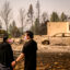 A couple visits their home destroyed by the Old Trails Fire in Spokane, Wash., on Tuesday. Credit: Josh Edelson/AFP via Getty Images