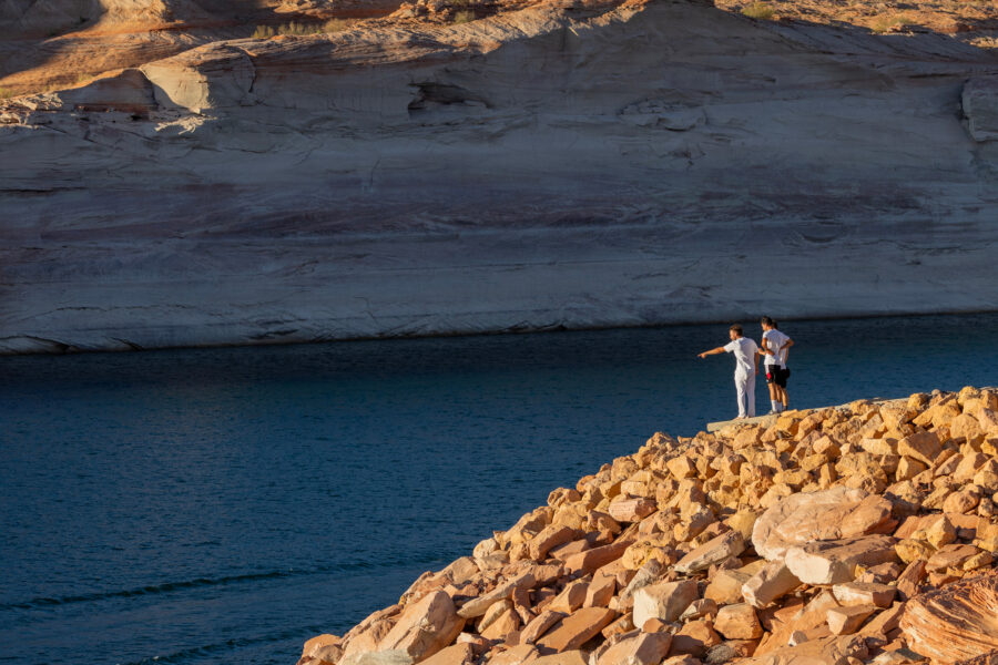 People stand at the bottom of a boat ramp that now ends hundreds of feet above the water levels of Lake Powell on Aug. 18 near Page, Ariz. Credit: David McNew/Getty Images