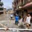 Locals walk through houses deluged in sludge after flash floods in Nepal’s Nuwakot district on Thursday. Credit: Prabin Ranabhat/AFP via Getty Images