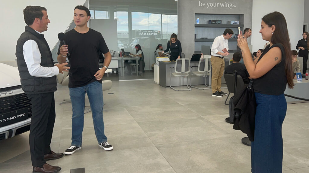 Argentine influencers interview BYD sales manager Franco Bornancini inside the BYD dealership in Córdoba on April 24. Credit: Katie Surma/Inside Climate News