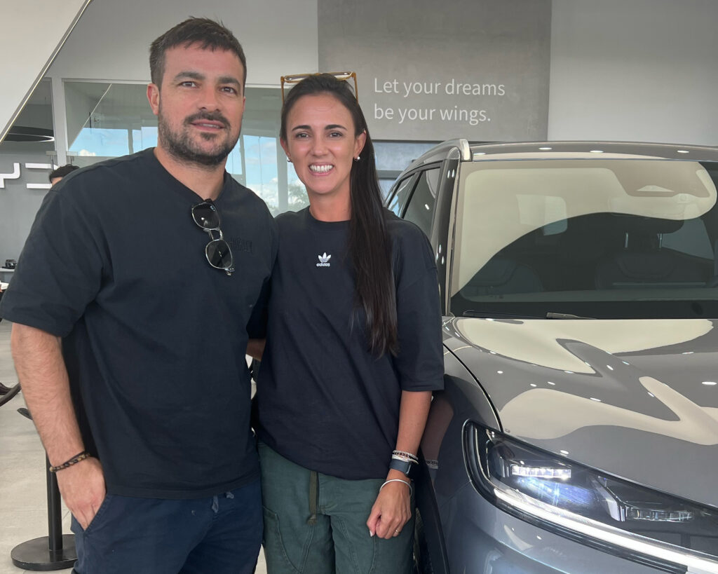 Cecilia Díaz and Nicolás Quiroga, parents of two, pick up their new BYD Yuan Pro, a hybrid SUV. Their decision was driven largely by the rising cost of gasoline since the U.S.-Iran war began. Credit: Katie Surma/Inside Climate News