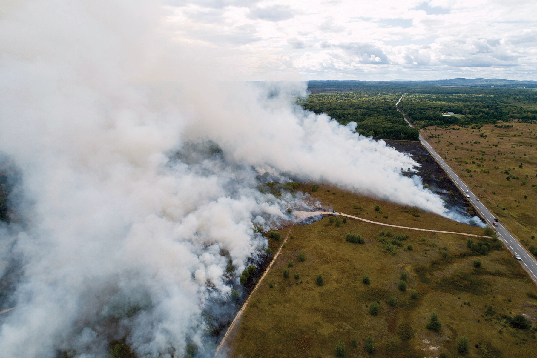 An aerial view of a prescribed burn by the Nature Conservancy in Kennebunk Plains Preserve in Maine. The Nature Conservancy is one of the primary practitioners of prescribed fire as a way to prevent more dangerous fires. Credit: Jerry and Marcy Monkman/EcoPhotography