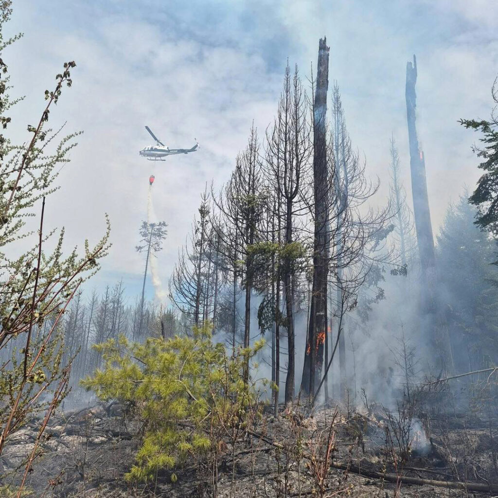 A helicopter assists in putting out a wildfire at Pine Stream, Maine. The Maine Forest Service relies on helicopters, drones and boats to reach wildfires in more remote parts of the state. Credit: Maine Forest Service