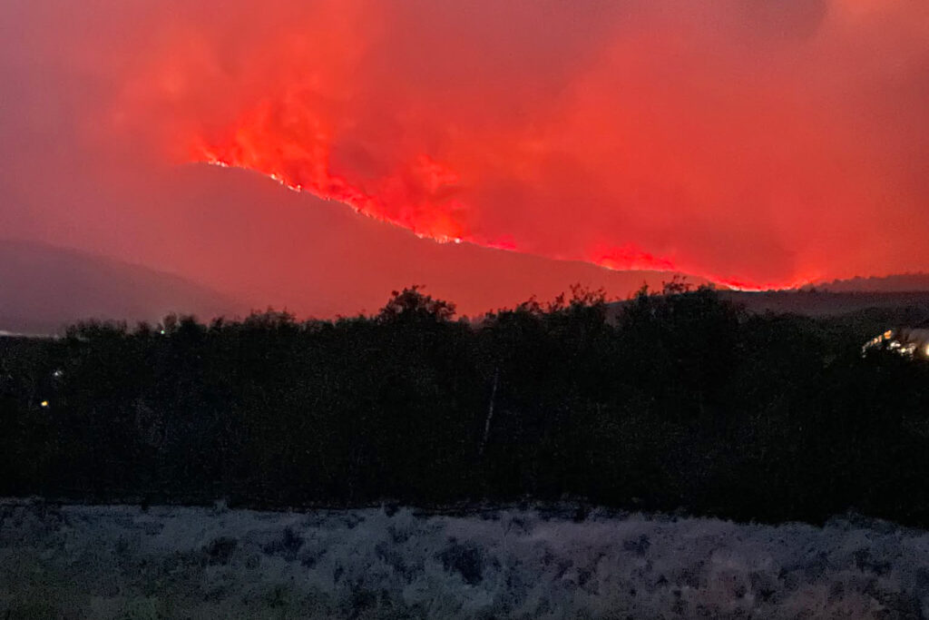 The Sand Creek Fire burns along a mountainside at Maverick Mountain Ski Area in southwestern Montana, sending a large plume of smoke into the sky. Credit: Beaverhead-Deerlodge National Forest Wildland Fire Information