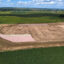 A former soybean field and six-acre earthen basin in Castana, Iowa, where a private developer planned to dump dehydrated manure from an out-of-town slaughterhouse. Credit: Scott Koepsell