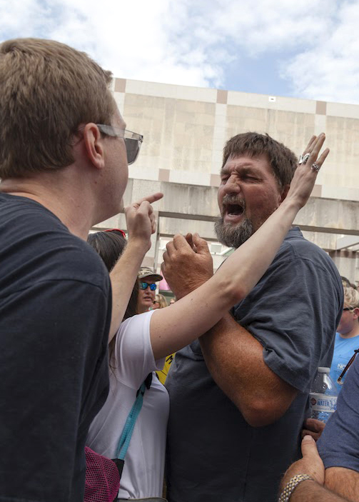 In 2018, after hundreds of residents sued Smithfield Foods for nuisance related to the lagoon and sprayfield system of waste management, farmers rallied near the North Carolina Legislative Building in support of the pork giant. A counter-protesters scuffled with an advocate for Smithfield. Credit: Lisa Sorg/Inside Climate News