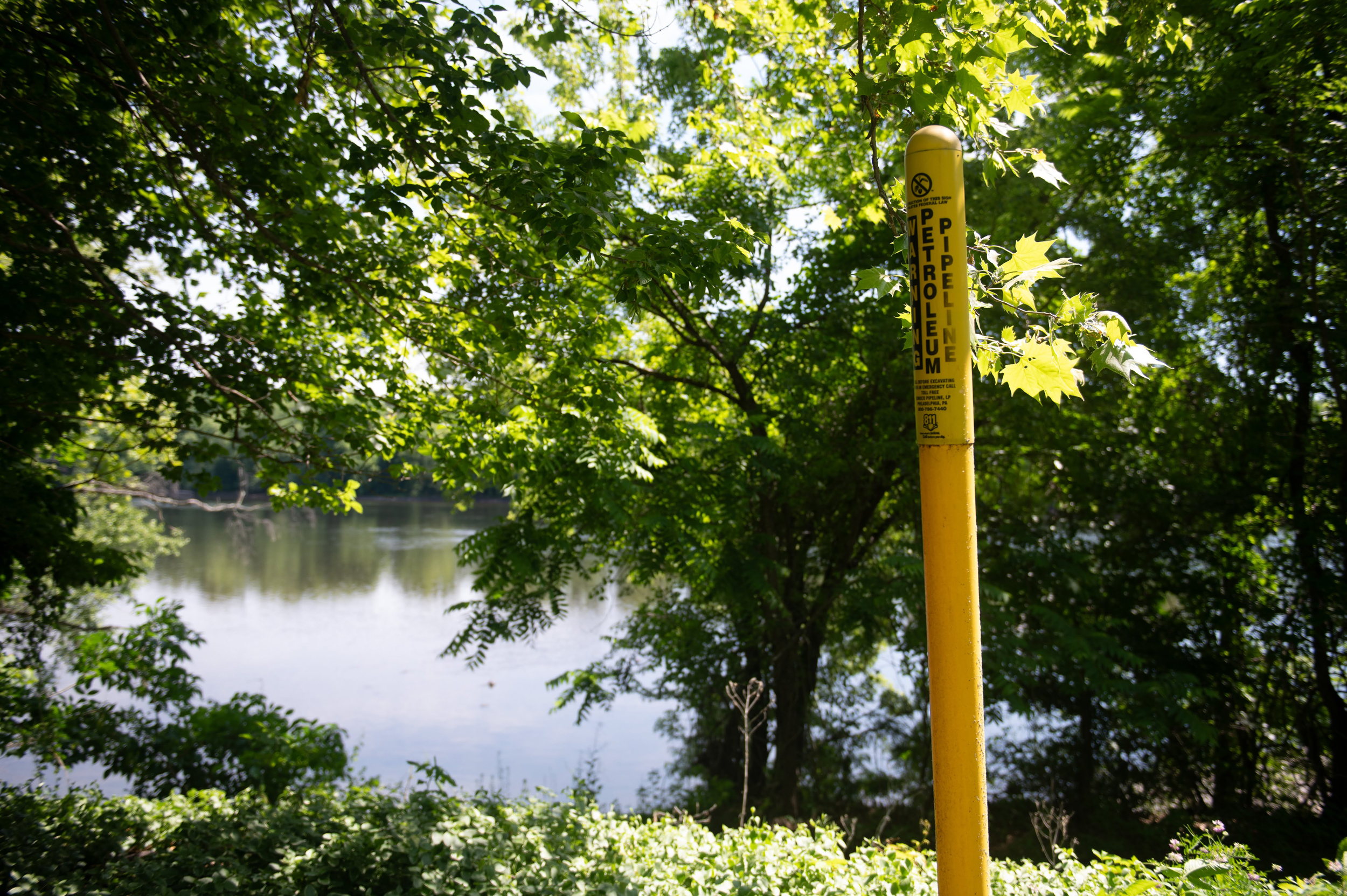 A marker for the petroleum pipeline stands near the Delaware River in Upper Makefield Township. The pipeline crosses the Delaware and travels into New Jersey to service the Newark airport. Credit: Tracie Van Auken/Inside Climate News