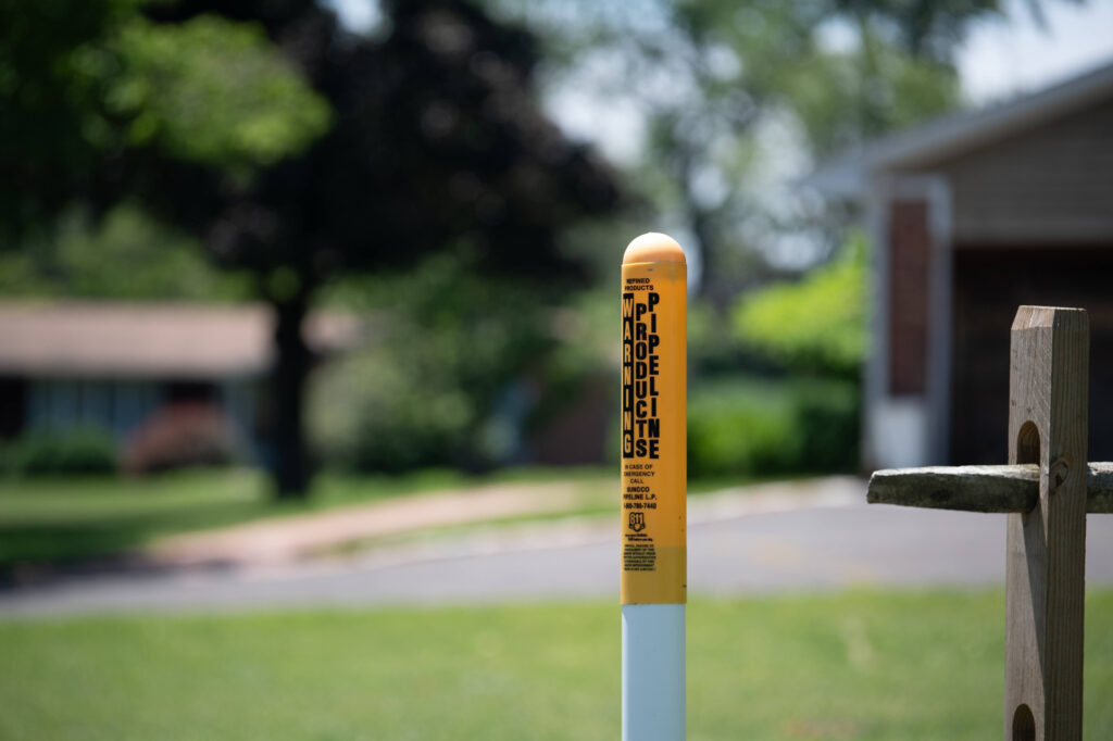 A petroleum pipeline marker stands near the intersection where the initial spill occurred in the Mt. Eyre Manor neighborhood of Upper Makefield Township. Credit: Tracie Van Auken/Inside Climate News