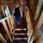 Krista Woodward walks through her stalled home reconstruction on July 1 in Lahaina. Credit: Kevin Fujii/Civil Beat
