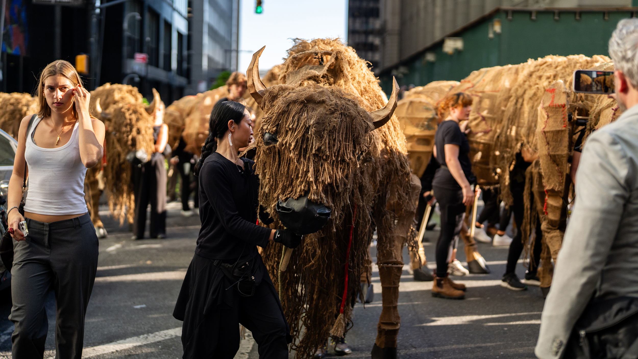 The buffalo march started chaotically, with the puppets having to move off the sidewalk to avoid an oncoming firetruck. Credit: Jake Bolster/Inside Climate News
