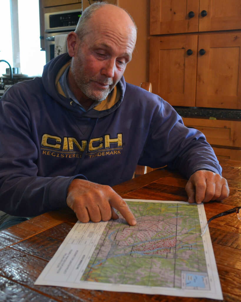 Nick Wilkinson, a local rancher in the McDermitt Caldera, points to a map displaying mining claims where his cattle graze. Credit: Wyatt Myskow/Inside Climate News