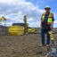 Shannon Dunphy, director of Mountain West construction at Dandelion Energy, oversees installation of polyurethane pipes for a geothermal system in Littleton, Colo. Credit: Phil McKenna/Inside Climate News