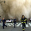 Police and firefighters run away from a toxic dust cloud caused by the World Trade Center’s Tower One collapse in New York City on Sept. 11, 2001. Credit: Jose Jimenez/Primera Hora/Getty Images