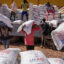 Volunteers unload sacks of wheat flour from USAID at a camp for internally displaced people on Dec. 17, 2021, in Bahir Dar, Ethiopia. Credit: J. Countess/Getty Images