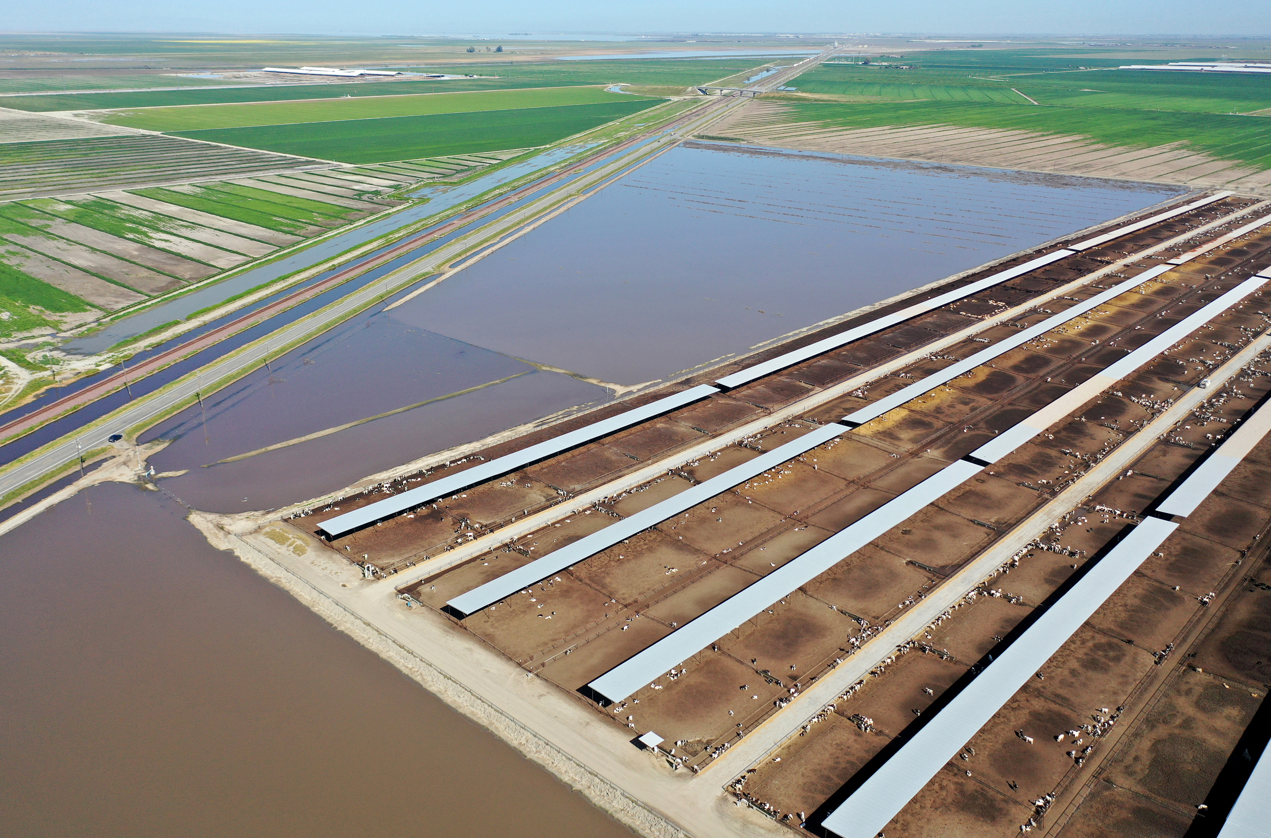 Flooded farmland surrounds a dairy in California’s Central Valley near Alpaugh on April 14, 2023. Credit: Mario Tama/Getty Images