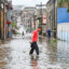 People walk through a flooded street in a neighborhood affected by Hurricane Melissa in Santiago de Cuba on Oct. 29, 2025. Credit: Yamil Lage/AFP via Getty Images