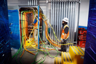 Construction workers wire electricity lines at a data center under construction on March 4 in Garland, Texas. Credit: Tom Fox/The Dallas Morning News via Getty Images