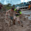 A rescuer assists a resident through heavy mud following flash floods on Aug. 27 in Trishuli, Nepal. Credit: Ezra Acayan/Getty Images