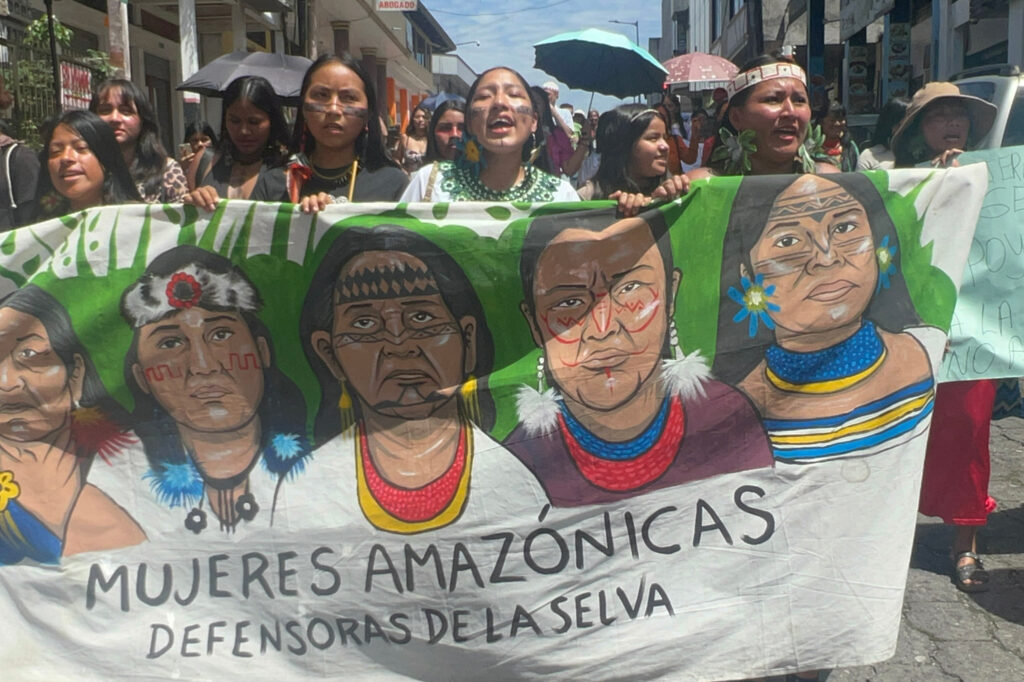 Female environmental defenders march on Aug. 21 in Puyo, Ecuador, calling on governments to respect their rights and the rights of nature. Credit: Katie Surma/Inside Climate News