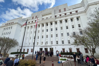 People gather outside the Alabama State House in March. Credit: Dennis Pillion/Inside Climate News