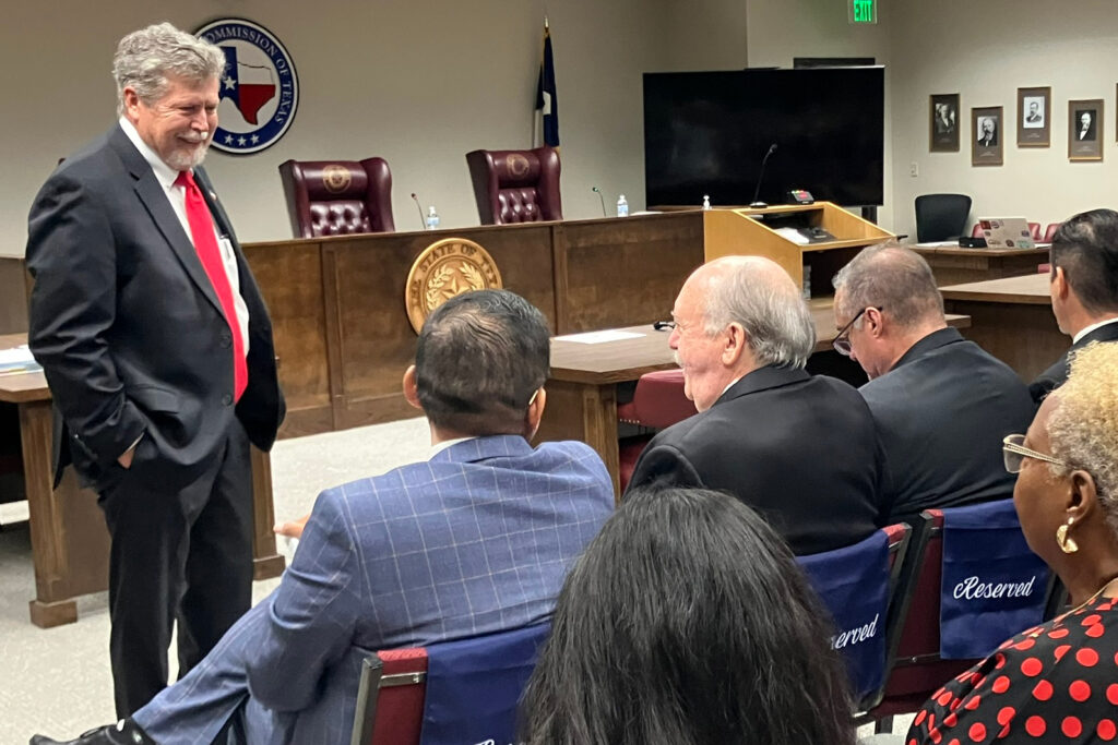 Railroad Commissioner Jim Wright greets agency staff before an open meeting on Tuesday. Credit: Martha Pskowski/Inside Climate News