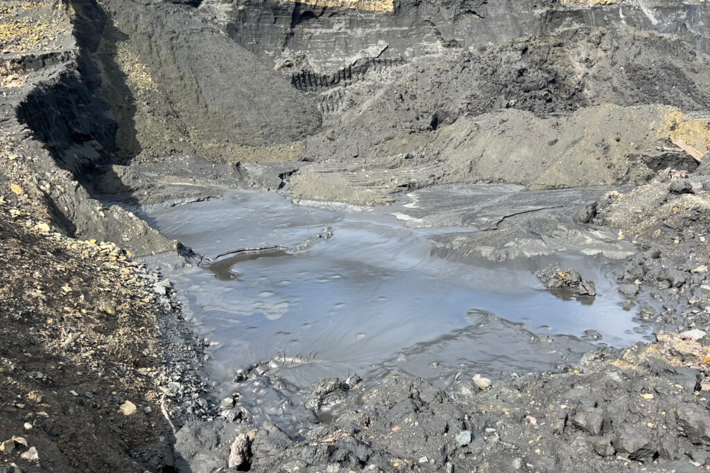 An inky pool sits in the middle of an anthracite coal pile. Credit: Jessica Klein/Inside Climate News