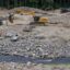 A construction crew from Sargent Corporation and engineers from Inter-Fluve work on the “nature-like fishway” that’s replacing a former ice-control dam on the Narraguagus River in Cherryfield. Credit: Katherine Emery/The Maine Monitor