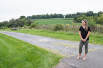 Nicole Williams’ home was built on land that once belonged to the farm behind her, which has been identified as the source of PFAS in her well. Credit: Ben Seal/Inside Climate News