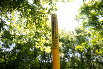 A marker for an Energy Transfer petroleum pipeline stands near the Delaware River in Upper Makefield Township, Pa. Credit: Tracie Van Auken/Inside Climate News