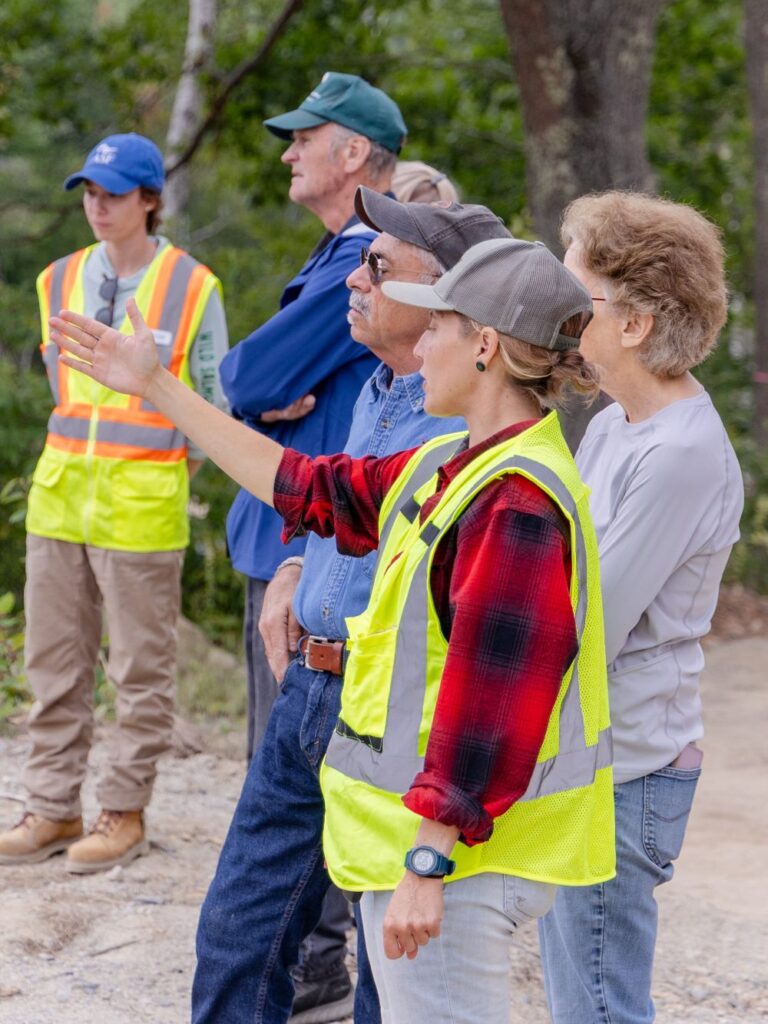 Cherryfield community members look at the ongoing construction to replace their former dam with a nature-like fishway. Credit: Katherine Emery/The Maine Monitor