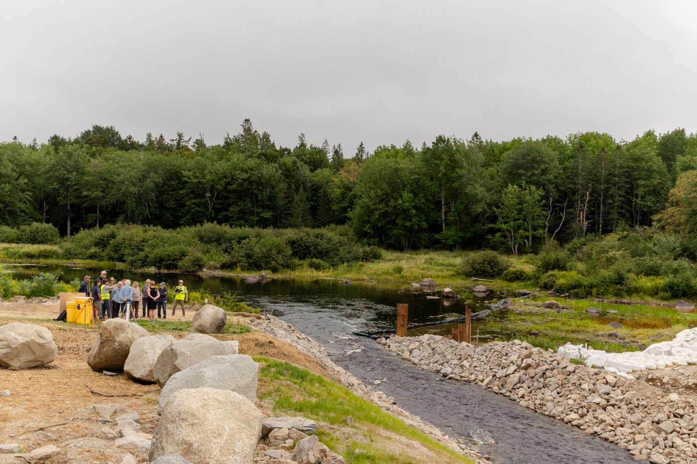 Members of the Cherryfield community, who voted unanimously to replace their town’s ice-control dam with a more natural alternative for fish, gather for a public tour of the project on Aug. 28. Credit: Katherine Emery/The Maine Monitor