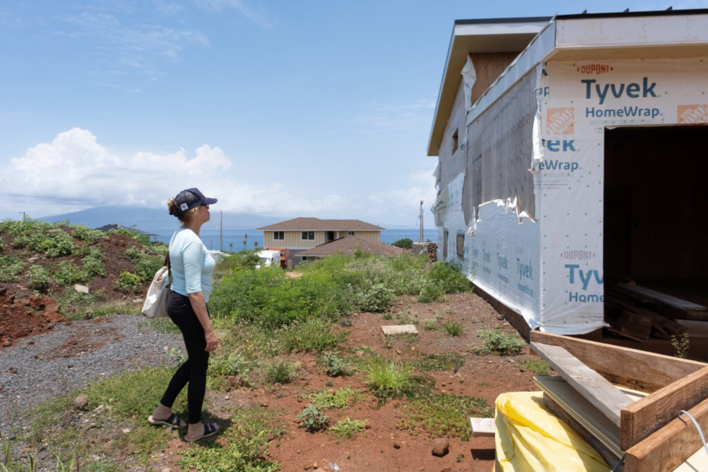 Krista Woodward surveys her unfinished home in May. Credit: Keerti Gopal/Inside Climate News