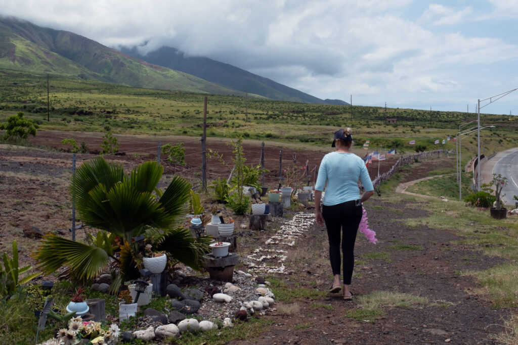Krista Woodward visits the Lahaina memorial to the lives lost in the 2023 fires, which burned down her home. Credit: Keerti Gopal/Inside Climate News
