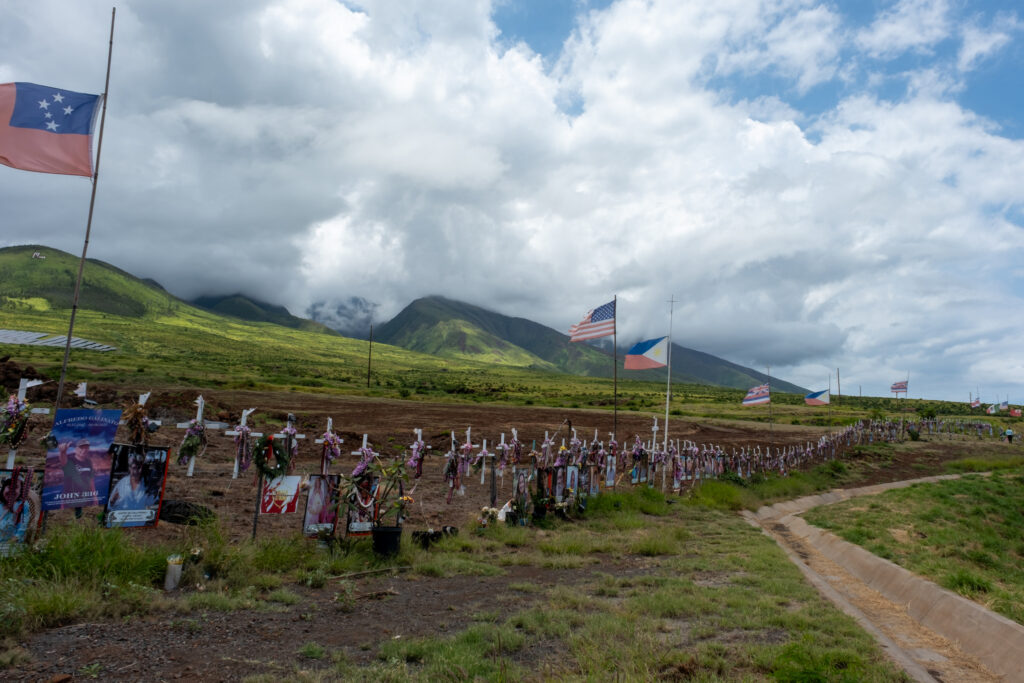 Lahaina residents lay flowers at a memorial for people who were killed in the 2023 fires, the deadliest the U.S. has seen in more than a century. Credit: Keerti Gopal/Inside Climate News