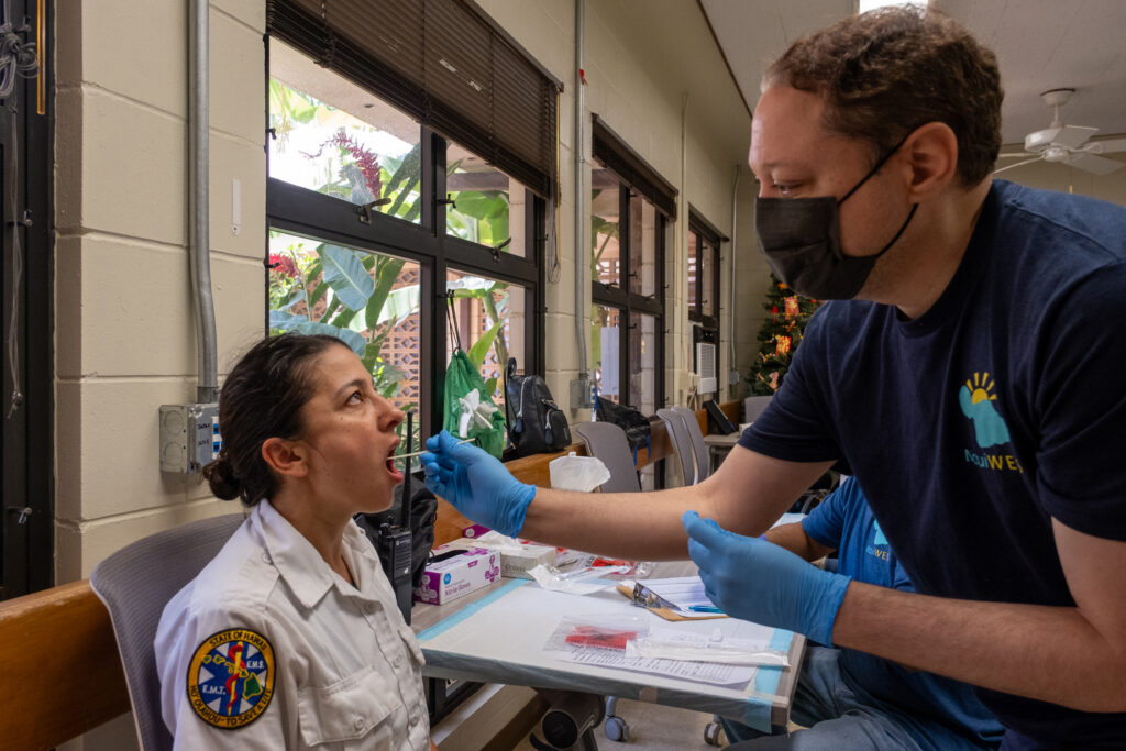 Alika Maunakea, co-director of MauiWES, takes a saliva sample from a first responder on Maui during one of the study’s data collection events. Credit: Keerti Gopal/Inside Climate News