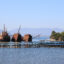 Derelict ships and fish farms near Preveza, Greece. Abandoned farms leach microplastics and release Styrofoam pellets, while their nets trap living creatures like crabs. Credit: Ryan Green/The Outlaw Ocean Project