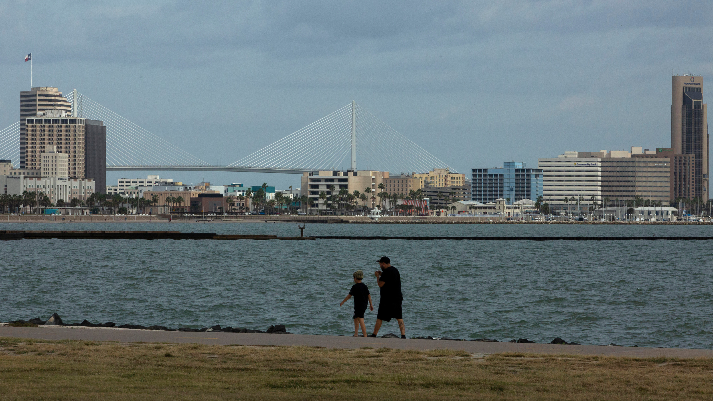 People stroll through Cole Park near downtown Corpus Christi on Oct. 25. Credit: Dylan Baddour/Inside Climate News