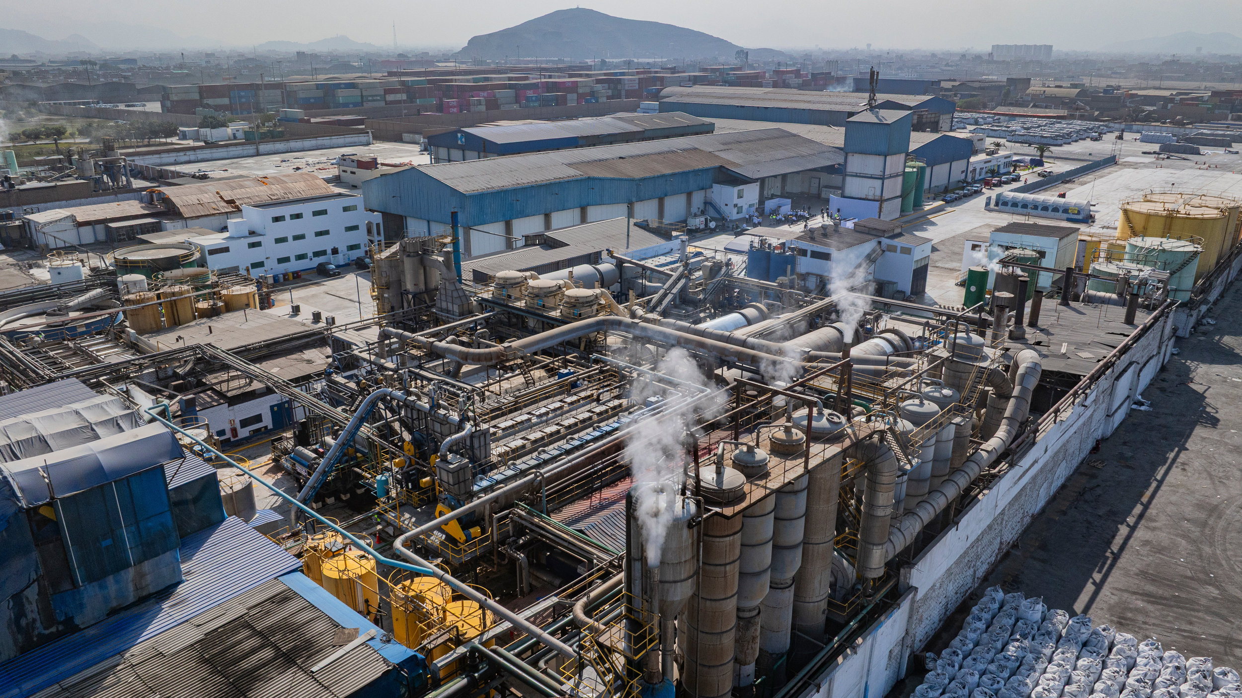 Smoke rises from a fishmeal factory in 2025 near a residential community in Callao, Peru. Credit: Ministry of Production of Peru