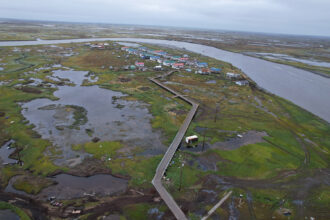 Debris from structures destroyed by Typhoon Halong litters the landscape near Kwigillingok, Alaska. Credit: Olga Loginova/Inside Climate News