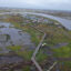 Debris from structures destroyed by Typhoon Halong litters the landscape near Kwigillingok, Alaska. Credit: Olga Loginova/Inside Climate News