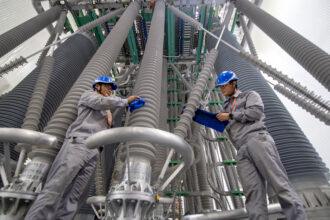 Maintenance workers clean substation equipment at in the Yanqing district of Beijing. Credit: CFOTO/Future Publishing via Getty Images